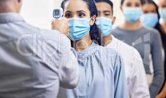 Complete your screening before heading into the office. Cropped shot of a group of businesspeople wearing masks lined up to be screened for covid 19.