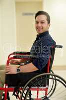 Here for my physio session. Portrait of a young man sitting in a wheelchair in a hospital.