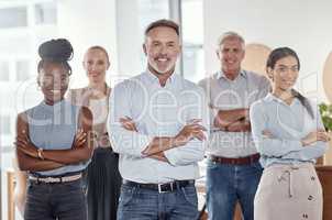 Team commitment makes a company grow. Portrait of a group of confident businesspeople working together in a modern office.