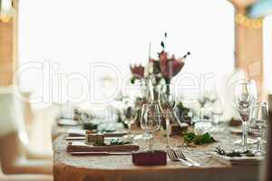 This special occasion calls for the best. Shot of a nicely set table with cutlery and crockery placed together inside of a building during the day.