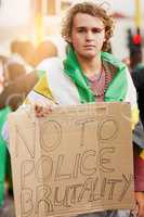 Weve had enough. Portrait of a young protester holding a anti police brutality sign at a rally.
