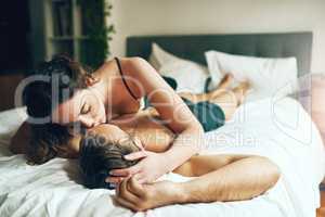 The bedroom was made for romance. Shot of an affectionate young couple spending a romantic morning in bed at home.