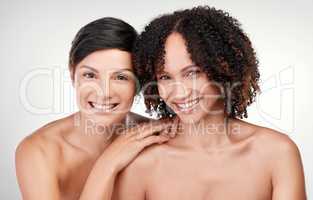 Beauty in contrast. Cropped portrait of two beautiful mature women posing against a grey background in studio.