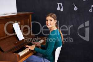 Using illustrations to teach her students. Shot of a woman playing the piano against a background of musical notes.