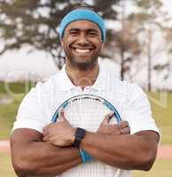 On my way to becoming world champion. Shot of a handsome young man standing alone outside and posing with a tennis racket.