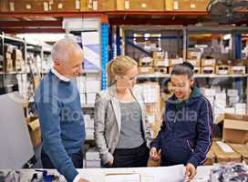 Last minute order revisions. Shot of managers at work supervising a shipping and distribution business.