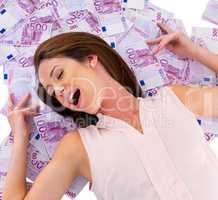 Money beds are so comfortable. Studio shot of a young woman with money to spend.