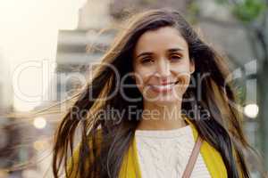 Beauty is contagious, spread it everywhere you go. Portrait of a young woman smiling and in good spirits in the city.