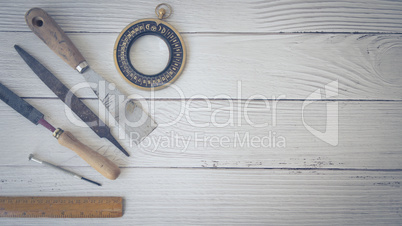 Handyman's tools on wood background.