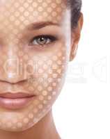 Beauty one dot at a time. Conceptual studio portrait of a young ethnic woman with a dot matrix overlay on her face.