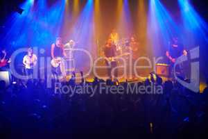 This band always delivers. Shot of a large crowd at a music concert- This concert was created for the sole purpose of this photo shoot, featuring 300 models and 3 live bands. All people in this shoot are model released.