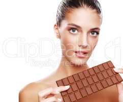 Chocolate cravings. Studio portrait of an attractive young woman holding a slab of chocolate.