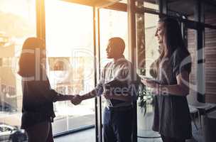 Looking forward to doing business together. Cropped shot of businesspeople shaking hands in an office.