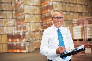 Success is grasping opportunities. A storage warehouse manager standing in the factor amidst many boxes.