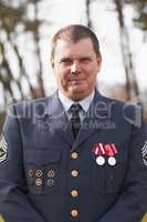 He has earned his medals. Cropped portrait of a high ranking military official standing outside.