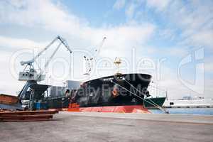 This is where the goods depart. A photo of a harbor with anchored ships.