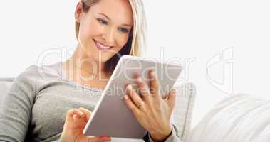 Convenience at my fingertips. Cropped portrait of an attractive young woman using a tablet in her home.