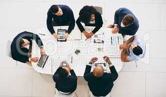 Developing strategies that produce strong results. High angle shot of a group of businesspeople having a meeting in a modern office.