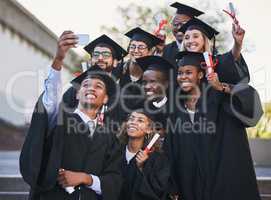 We earned our bragging rights. Shot of a group of students taking a selfie on graduation day.