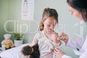 Itll be over quickly. Shot of a pediatrician cleaning her young patients arm with a cotton ball.