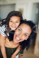 Every minute together is so enjoyable and precious. Portrait of a mother and daughter bonding together at home.