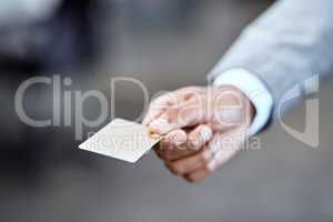 No need to ever carry cash again. Closeup shot of an unrecognizable businessman holding a credit card in an office.