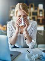 Great just what I wanted. Shot of a frustrated businesswoman using a tissue to sneeze in while being seated in the office.