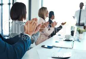 Ending off another incredibly successful meeting. Shot of businesspeople applauding during a presentation in an office.