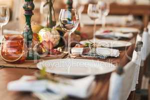 Ready to serve lunch. Shot of a nicely set diner table with different kinds of plates and glasses on it.