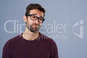 How bout no. Studio shot of a handsome young man looking doubtful against a gray background.