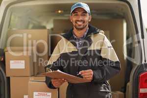 Deliveries are right on schedule. Portrait of a smiling delivery man standing in front of his van holding a package.