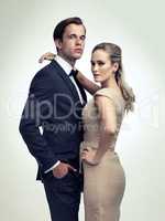 An air of sophistication. A studio portrait of a couple in stylish vintage evening wear.