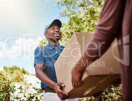 Delivering direct to your door. Shot of a young postal worker delivering a package to a female customer.