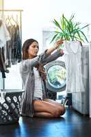 Wow, I swear there was a stain on here. Shot of a young attractive woman doing her laundry at home.