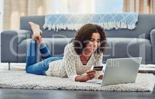 You can do it all online. Shot of an attractive young woman making payments online with a credit card.