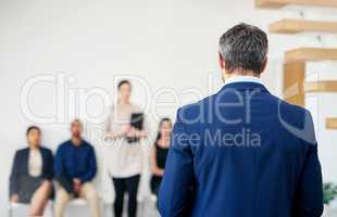 Next, please. Shot of an unrecognizable interviewer calling the next candidate to interview.