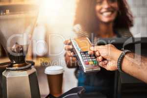 The smart, effortless and easy way to pay. Closeup shot of a customer making a credit card payment in a cafe.