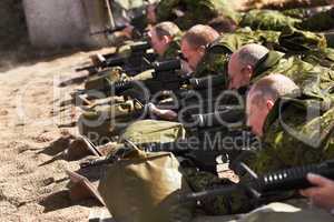 Training to be sharpshooters. A line of soldiers lying and aiming with their guns.