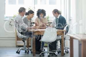 Putting their ideas on the table. Real life businesspeople shot on location. Since these locations are the real thing, and not shot in an "office studio", high ISO levels are sometimes needed to catch the moment. The ISO range is between 250-600 so it sho