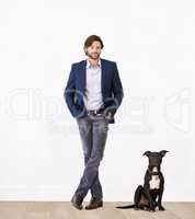 Proud of his canine sidekick. A handsome man standing next to his dog - portrait.
