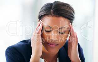 Nothing crushes a career like stress. Shot of a young businesswoman experiencing stress while working in a modern office.