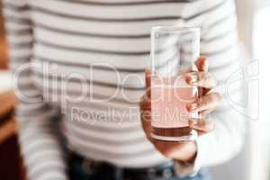 Get a good dose of health in a glass. Cropped shot of a woman having an effervescent drink at home.