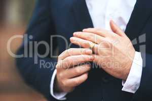 He's ready to tie the knot. Cropped shot of an unrecognizable bridegroom adjusting his ring on his wedding day.