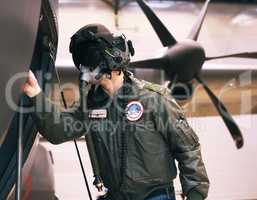 Prepping for war. Shot of a fighter pilot inspecting his aircraft.