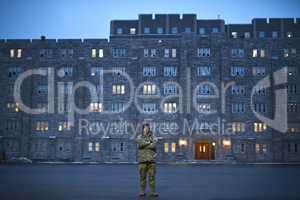 24/7 property protection. Shot of a young soldier standing outside on a cold day at military school.