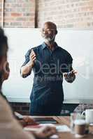 Leadership starts with self-confidence. Shot of a businessman giving a presentation to his colleagues in a boardroom.