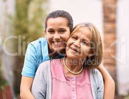 Shes like a mother to me. Portrait of a senior patient outside with her caregiver.