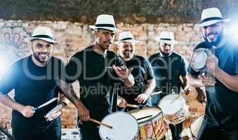 Let the music grab you. Cropped shot of a group of men drummers playing music outside.