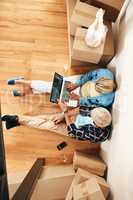 They found the best wifi hotspot in their new house. High angle shot of a mature couple using a laptop together on moving day.