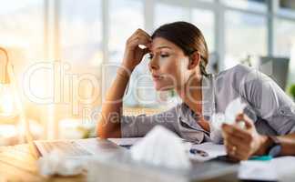 Trying to cope but her allergies are getting to her. Cropped shot of a businesswoman working in her office while suffering from allergies.